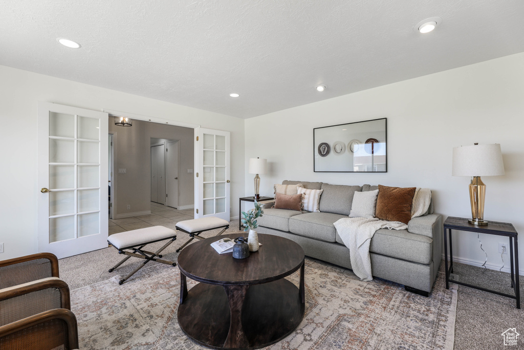 Living area with carpet flooring, baseboards, french doors, and recessed lighting