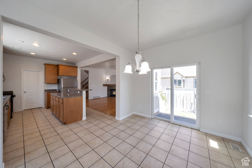 Kitchen featuring visible vents, baseboards, freestanding refrigerator, and light tile patterned floors