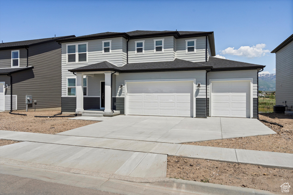 View of front of home with driveway and an attached garage