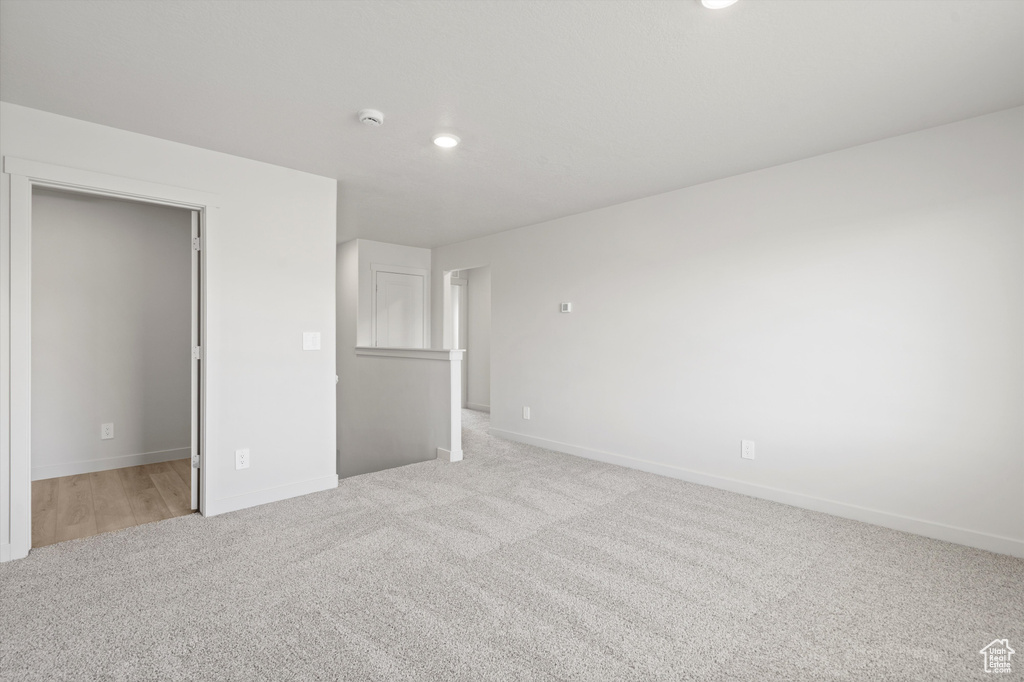 Unfurnished bedroom featuring light colored carpet and recessed lighting