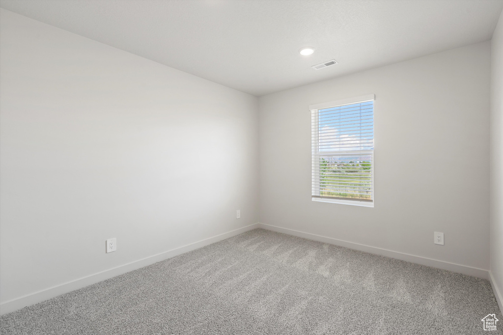 Unfurnished room featuring baseboards and light colored carpet