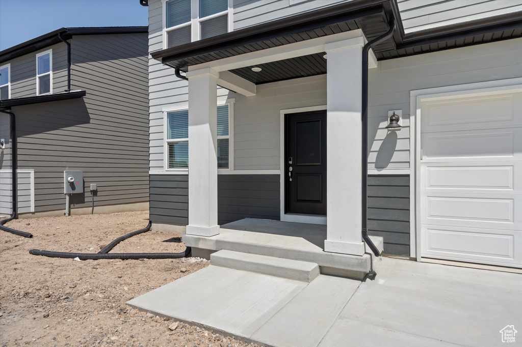 Entrance to property featuring an attached garage