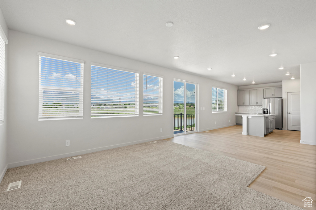 Unfurnished living room featuring recessed lighting and light wood finished floors