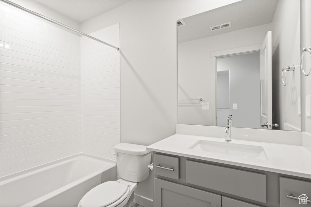 Bathroom featuring vanity and  shower combination
