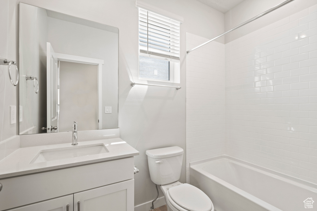 Full bath featuring vanity, bathing tub / shower combination, and toilet
