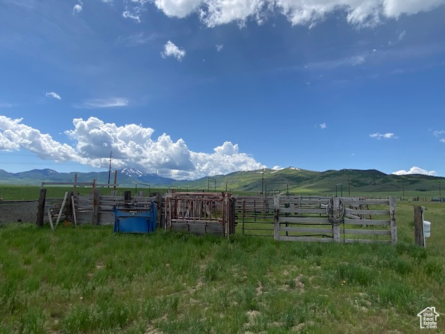 View of yard featuring fence, a rural view, and a mountain view