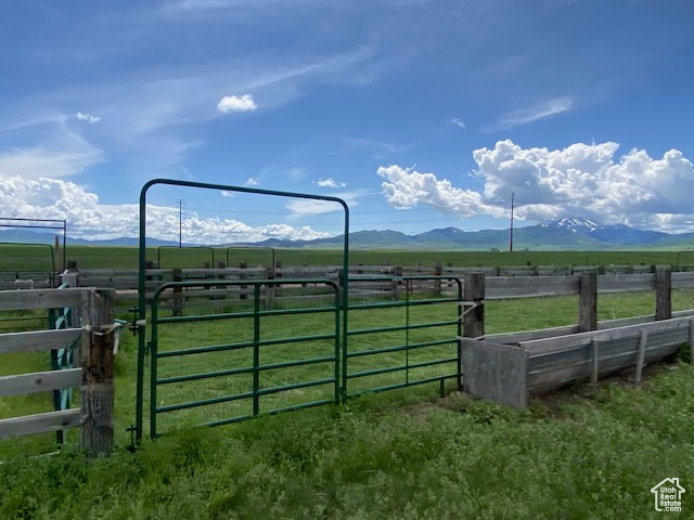 View of gate featuring a rural view and a mountain view