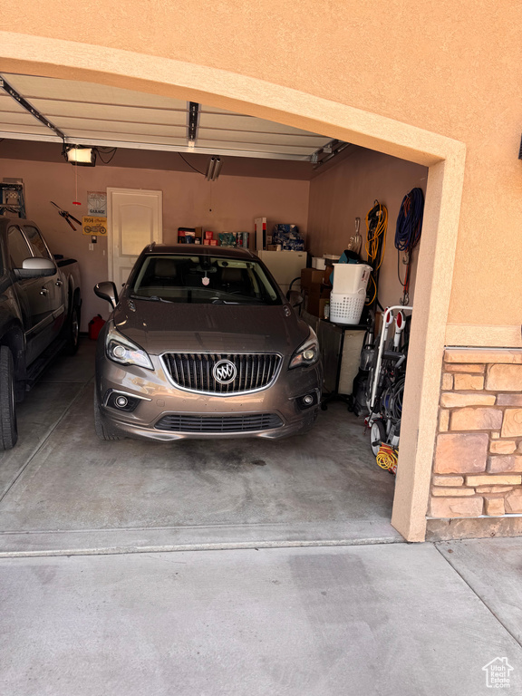 Garage with a garage door opener and concrete driveway