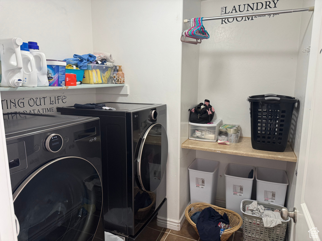 Laundry room with tile patterned floors, washer and dryer, and laundry area