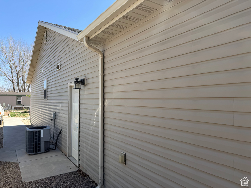 View of side of property with cooling unit