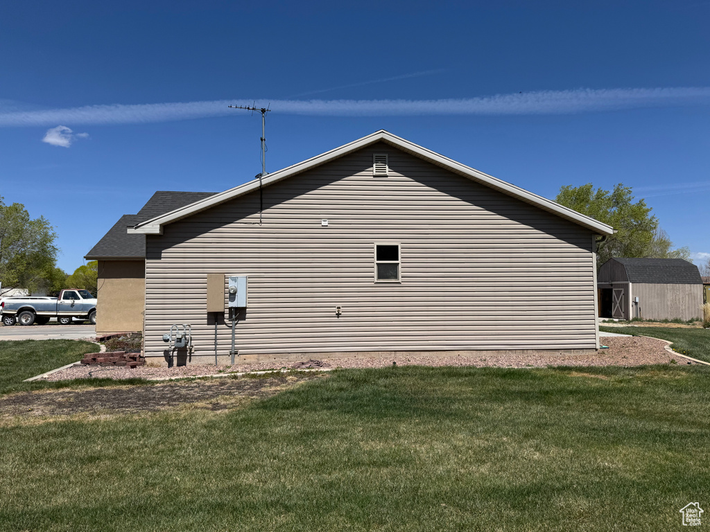 View of side of home featuring a yard