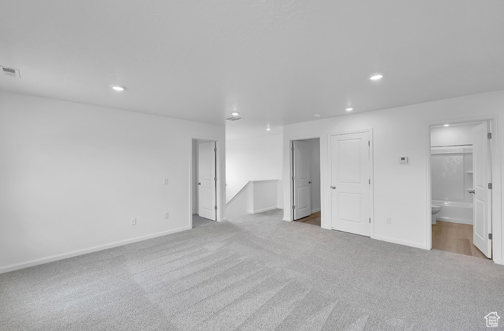 Unfurnished bedroom featuring carpet flooring, recessed lighting, baseboards, and ensuite bathroom
