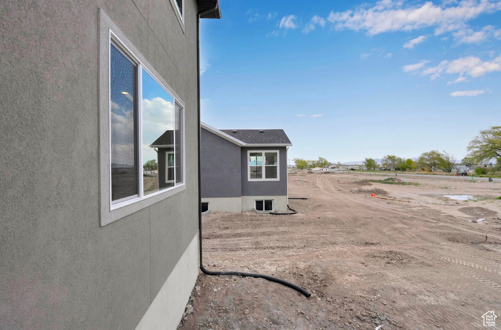 View of side of home featuring stucco siding