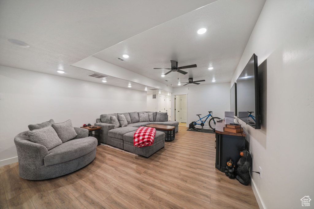 Living room featuring recessed lighting, baseboards, light wood finished floors, and visible vents
