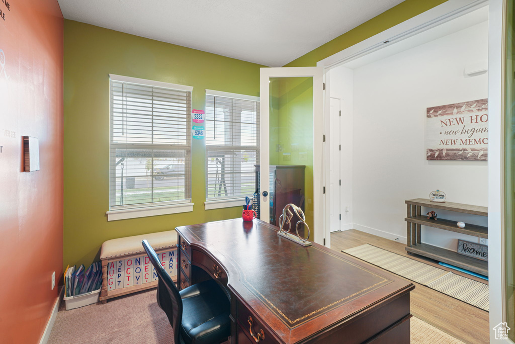 Office with baseboards, wood finished floors, and a wealth of natural light