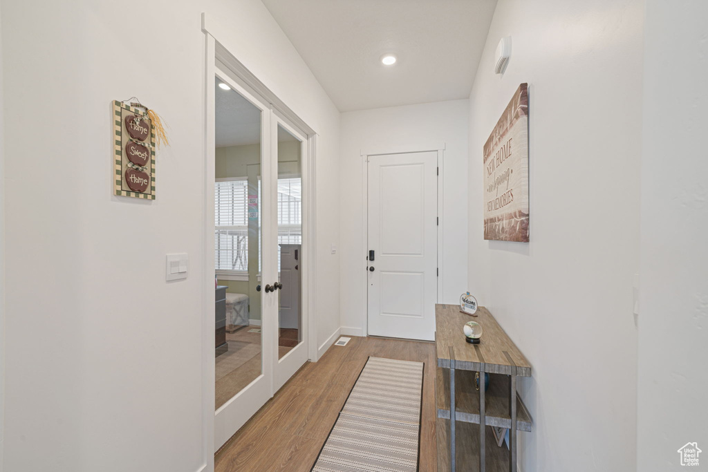 Entryway with baseboards, french doors, recessed lighting, and wood finished floors