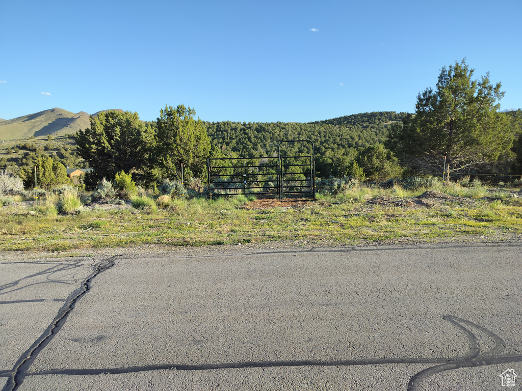 View of asphalt street featuring a mountain view