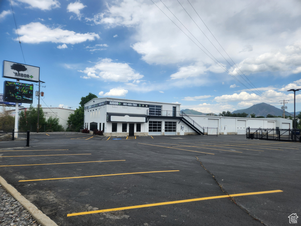 Uncovered parking lot featuring a mountain view
