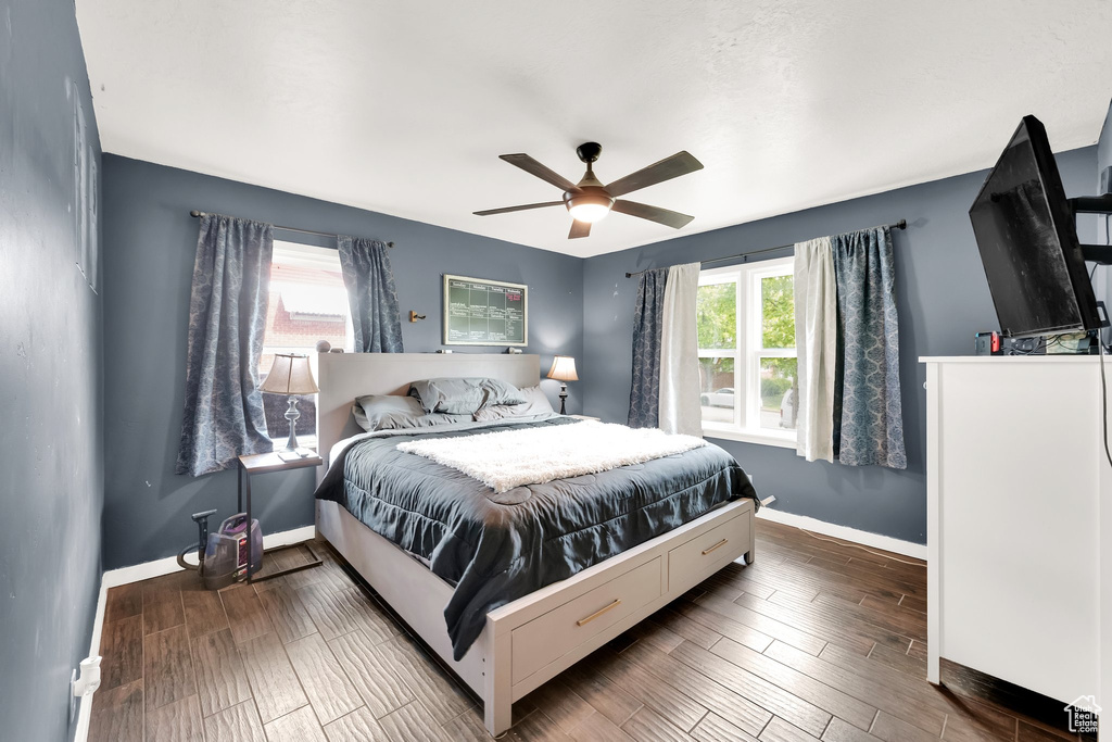 Bedroom featuring baseboards, ceiling fan, and wood finished floors