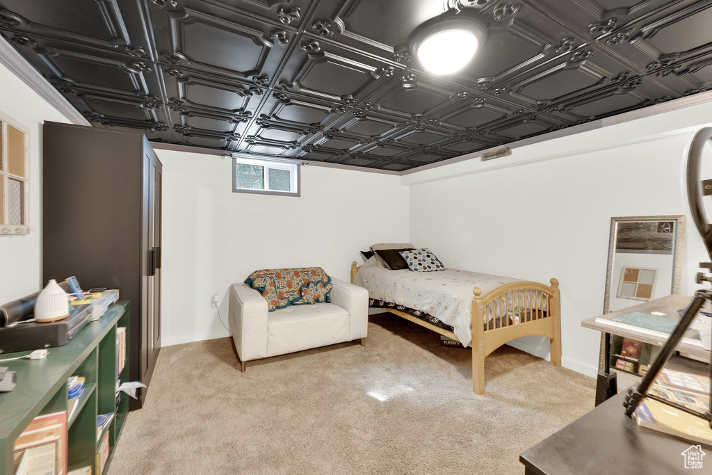 Bedroom featuring an ornate ceiling, light carpet, and visible vents