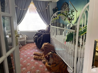Carpeted bedroom featuring baseboards