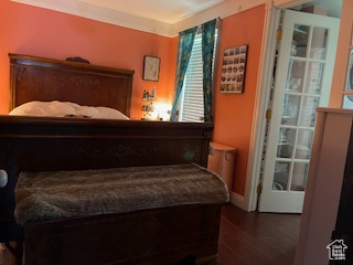 Bedroom featuring baseboards and dark wood-style floors