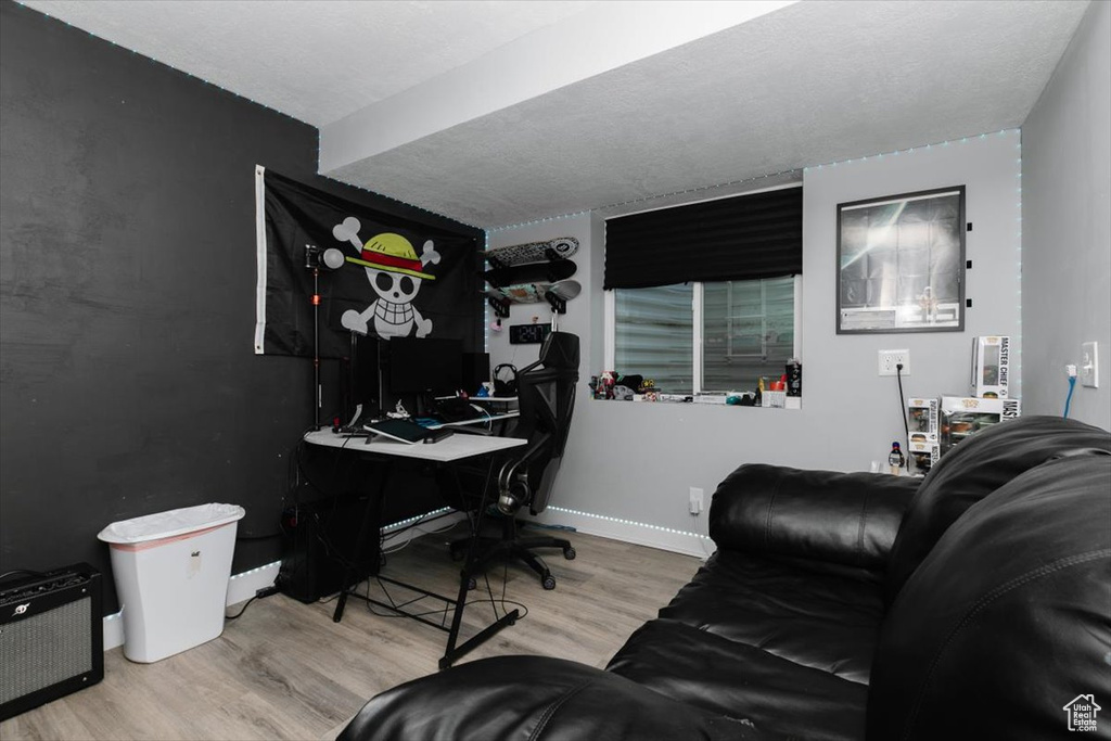 Office with baseboards and wood finished floors