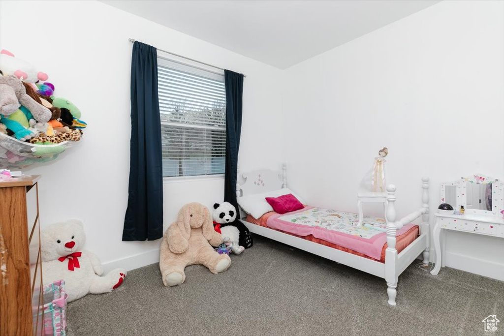 Bedroom with baseboards and carpet