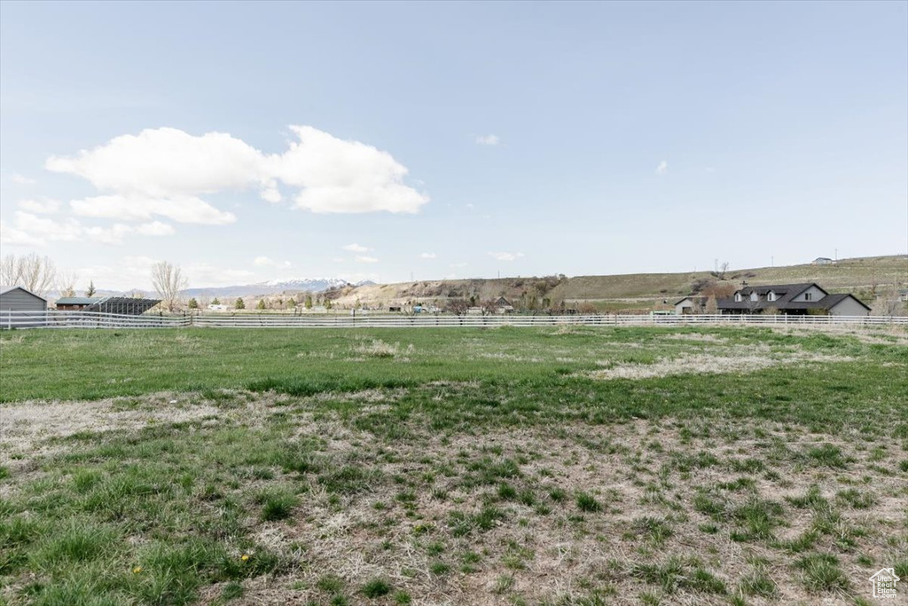 View of yard featuring a rural view and fence