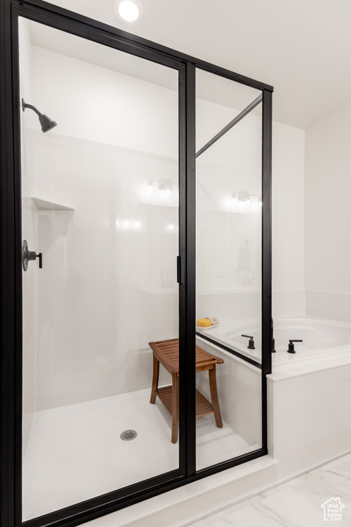 Full bath featuring a shower stall and a bath