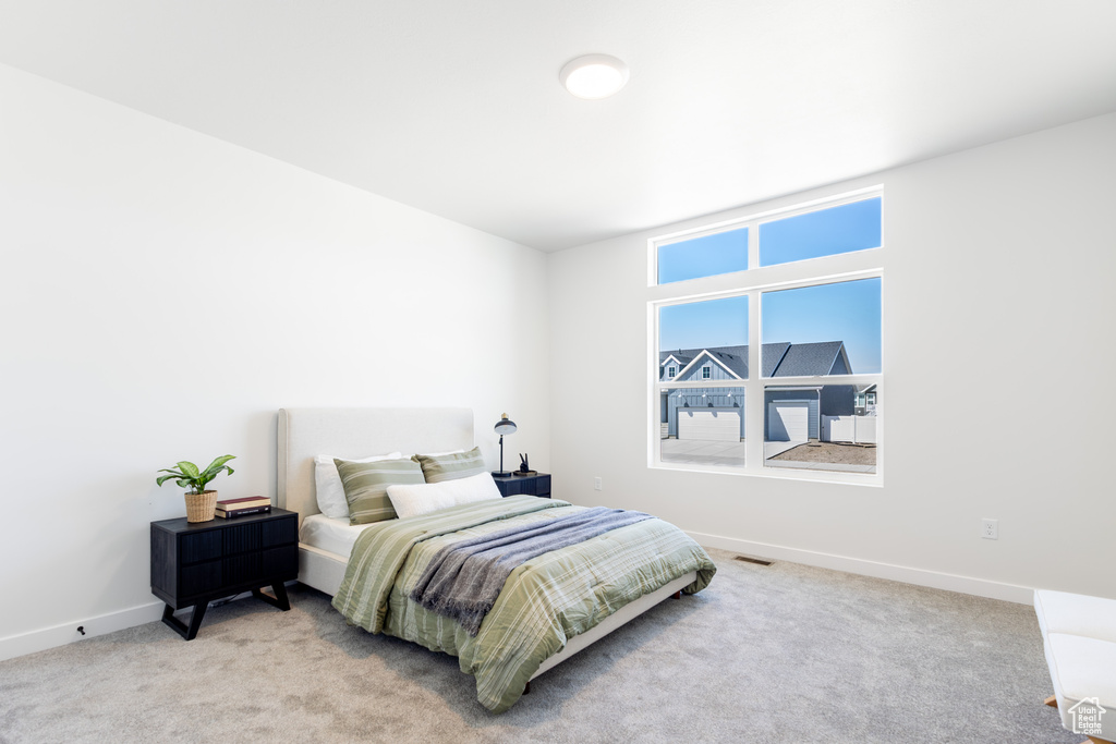 Carpeted bedroom featuring baseboards