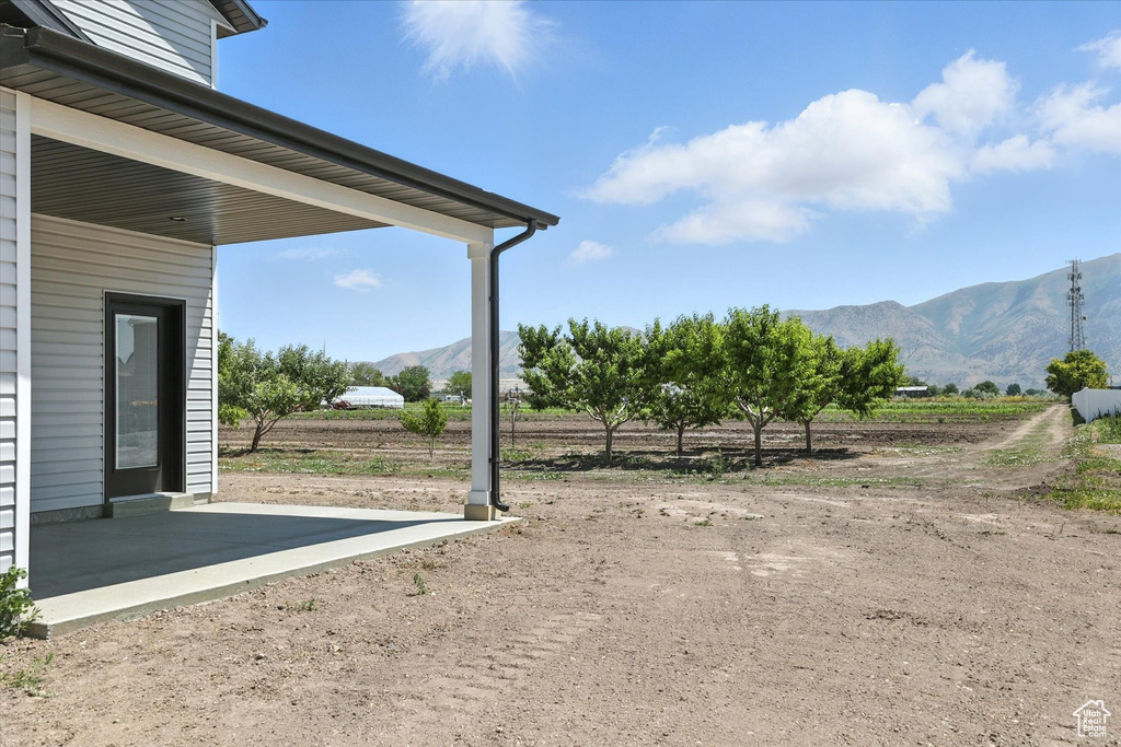 View of yard featuring a mountain view and a view of countryside
