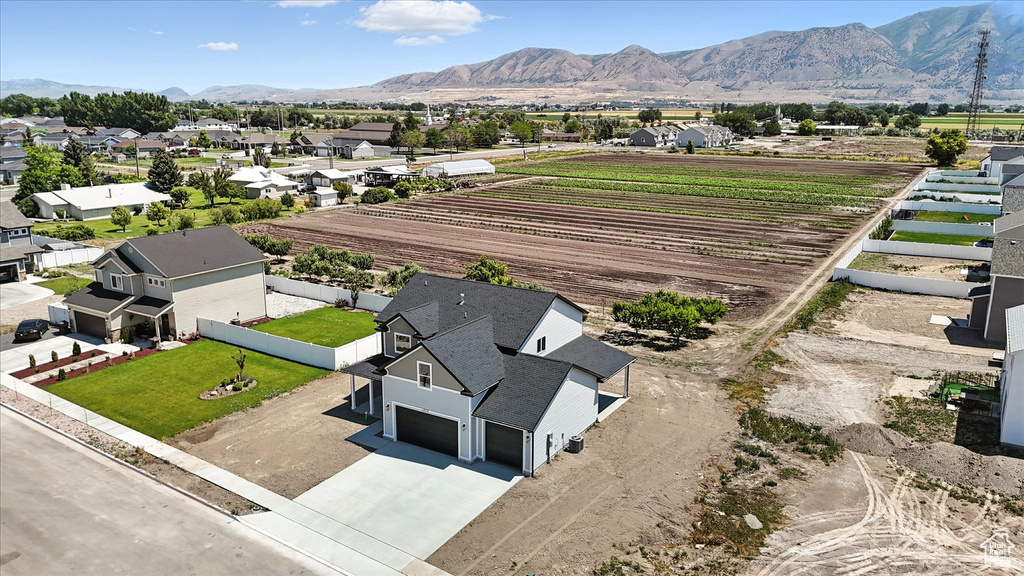 Aerial perspective of suburban area with mountains and farmland