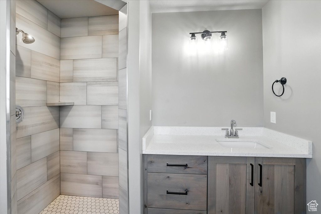 Bathroom with a tile shower and vanity