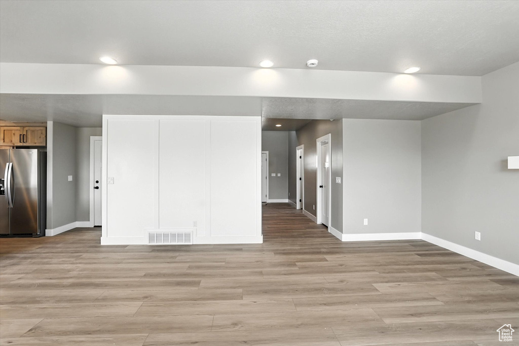 Unfurnished living room featuring light wood-type flooring and recessed lighting