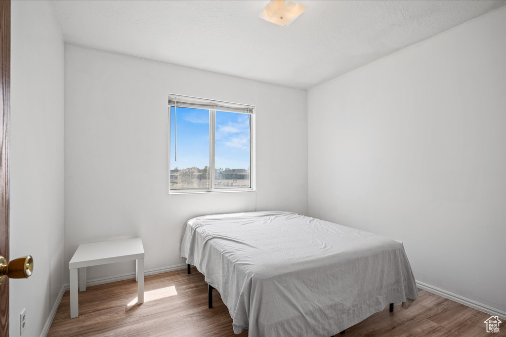 Bedroom featuring baseboards and wood finished floors