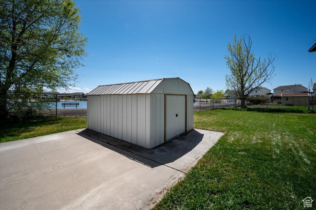 View of shed featuring fence