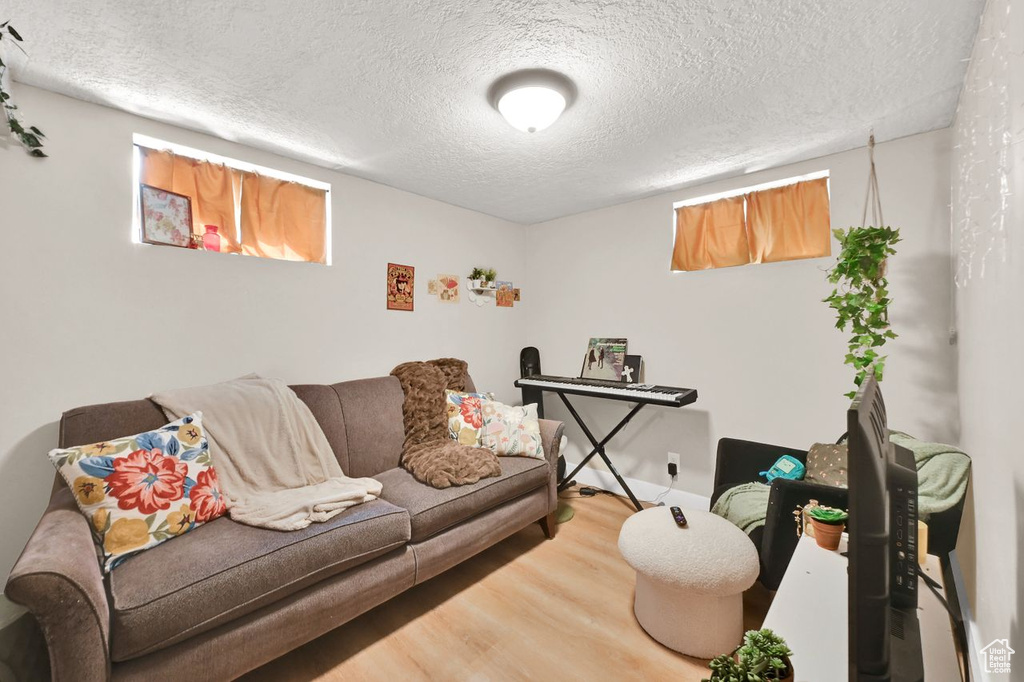Living room with wood finished floors and a textured ceiling