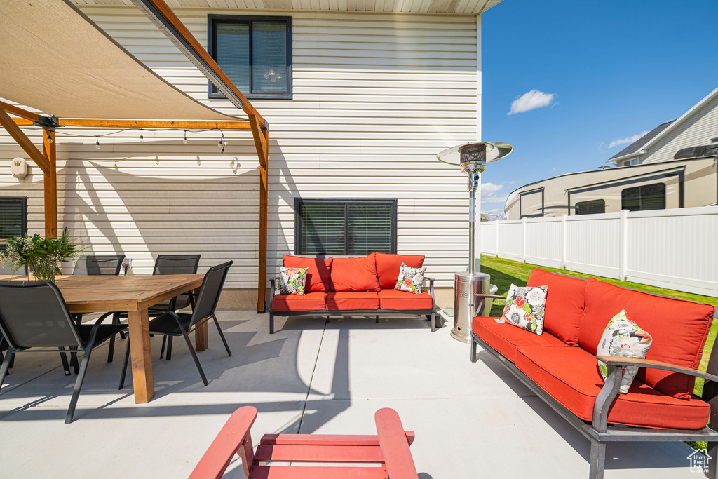 View of patio / terrace with fence, a pergola, outdoor lounge area, and outdoor dining area