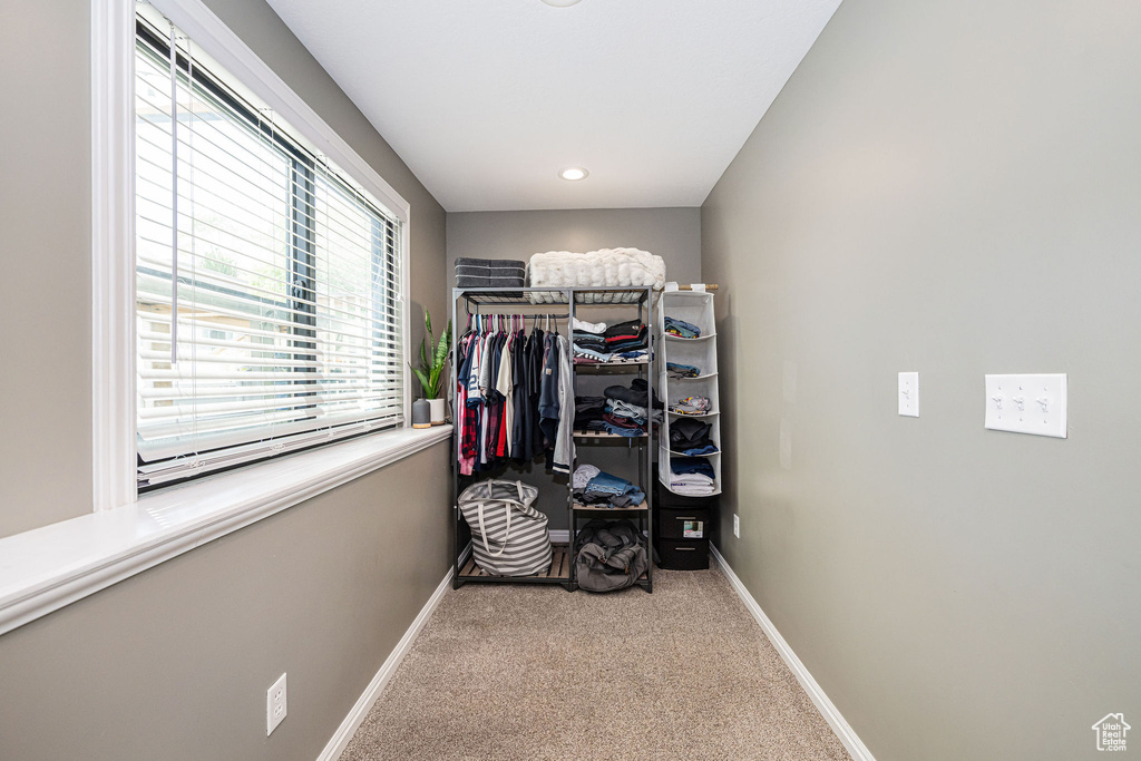 Walk in closet featuring carpet flooring