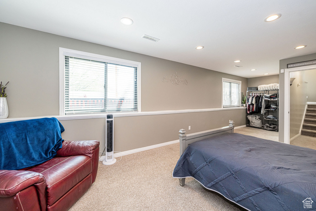 Bedroom featuring baseboards, recessed lighting, and light colored carpet