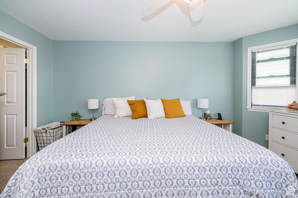 Bedroom with ceiling fan and carpet flooring
