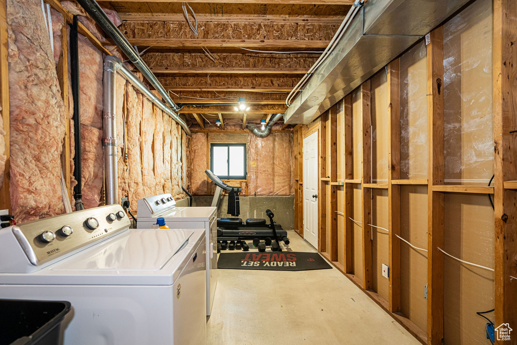 Washroom featuring separate washer and dryer and laundry area