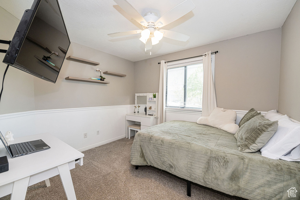 Bedroom with baseboards, a ceiling fan, and carpet