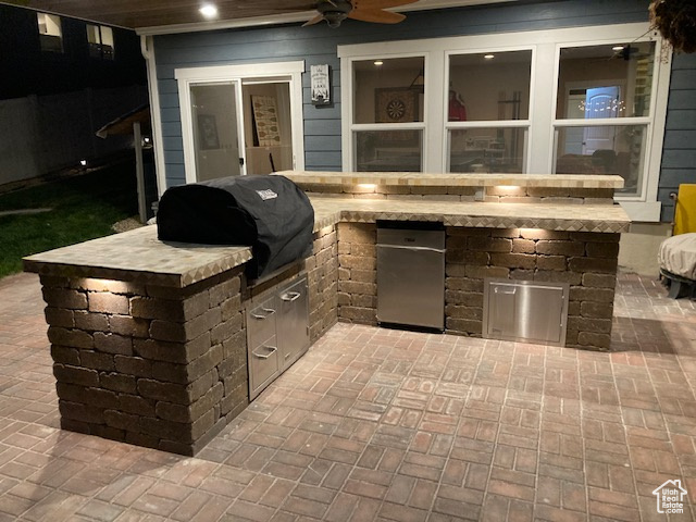 View of patio / terrace with grilling area, a ceiling fan, and area for grilling