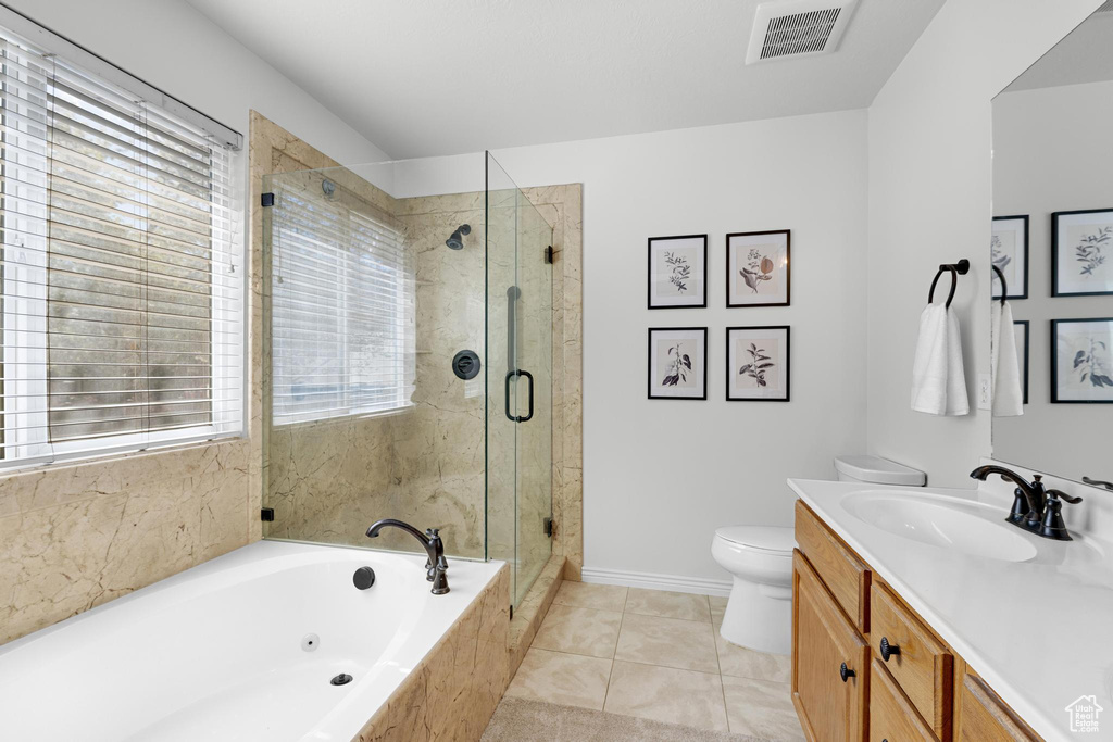 Bathroom with a shower stall, a tub with jets, vanity, toilet, and visible vents