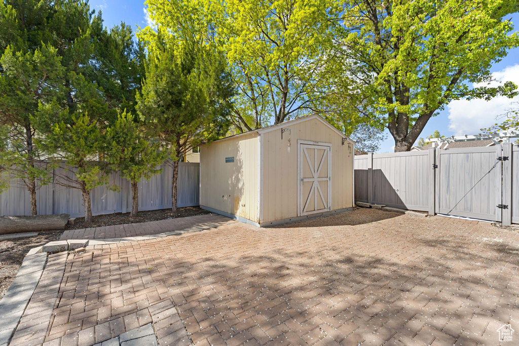 View of shed featuring a gate and a fenced backyard