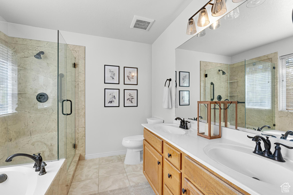 Full bathroom featuring a shower stall, a garden tub, a sink, and visible vents