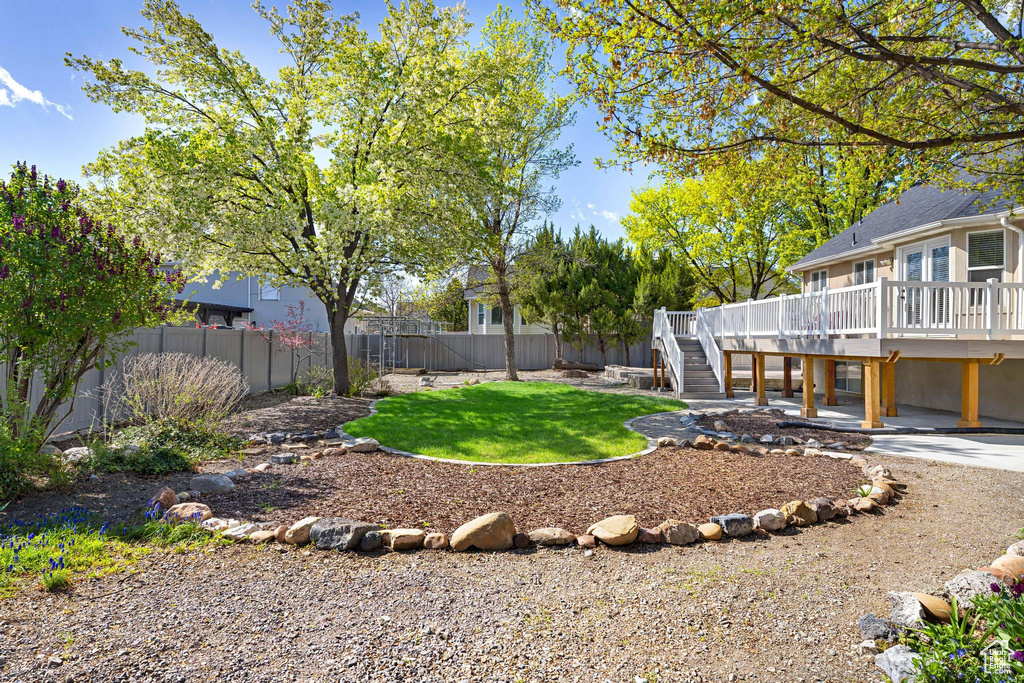 View of yard featuring a fenced backyard, stairway, a patio area, and a deck