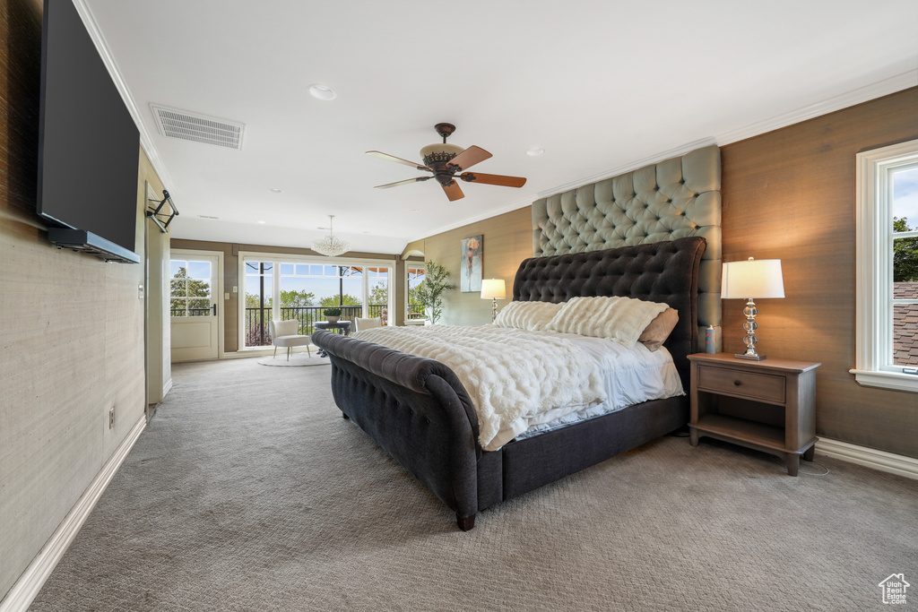 Carpeted bedroom featuring access to exterior, crown molding, and ceiling fan